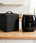 Heavy Duty Electric Frying Pan Protector Cover with handle next to a black air fryer on a wooden kitchen counter