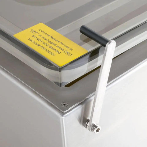 Close-up of the lock handle and safety warning label on Boss Level Floor Model Chamber Vacuum Sealer with Dual Twenty Inch Seal Bars.