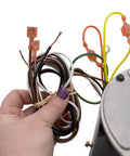 Hand holding wires of HVAC Condenser Motor Replacement 0.25 HP, 1 Phase, 208-230V, 825 RPM Model Specific, Built Tough for Pros