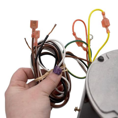 Hand holding wires of HVAC Condenser Motor Replacement 0.25 HP, 1 Phase, 208-230V, 825 RPM Model Specific, Built Tough for Pros