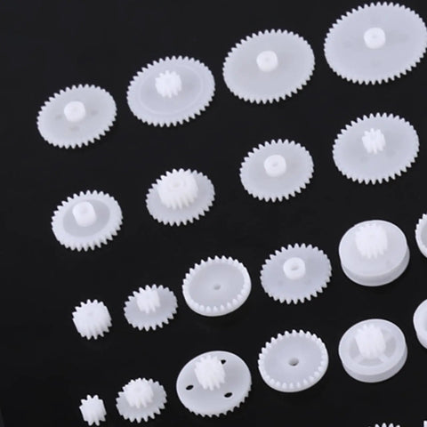 Durable Plastic Gear Kit Set For DIY Robots Cars And Tech Projects Includes 64 Wearable Crown Pulley Belt Gears Built Tough For Long Service Life Perfect For Creative Model Building And Mechanic Hobbyist Gadgets, assorted white ABS gears on black