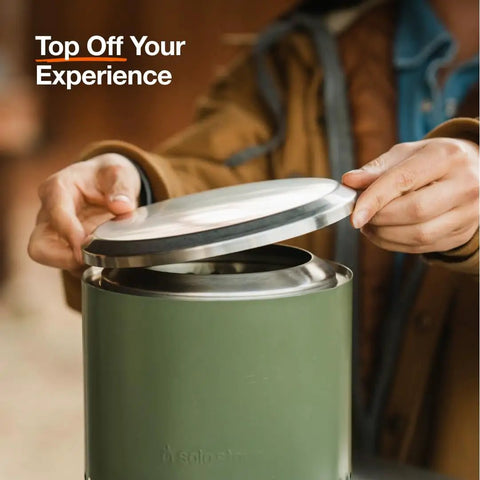 Person placing lid on a green Mesa Outdoor Fire Pit Accessory Pack With 4 Stainless Steel Mini Sticks Stick Rests Pellet Scoop Lid And Carry Case Essential Gear To Amp Up Your Tabletop Fire Pit Party And Keep The Night Lit