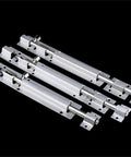 Darn Tough Stainless Steel Sliding Bolt Door Latch With Smooth Automatic Return Action Adjusts Easy For Indoor Outdoor Barn Gate Cupboard Top Shelf Security Hardware three stainless steel latches laid out on black background