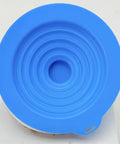 Top view of a blue silicone Drain Unclogger Flexible Bath Drain Cover Sealing Stopper, showcasing its unique spiral design.