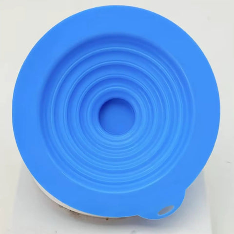 Top view of a blue silicone Drain Unclogger Flexible Bath Drain Cover Sealing Stopper, showcasing its unique spiral design.