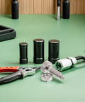 Hella Durable M10 Spring Plunger With Knurled Handle Dead Nuts Secure Self Locking Release Pin For Precision Mold Setup And Robotic Joints Rock Solid Quick Action Design on green work surface with pliers and accessories.