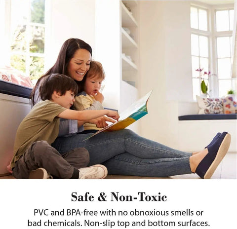 Woman reading to two children in a bright room with large windows and cushions, promoting a non-toxic and safe environment.
