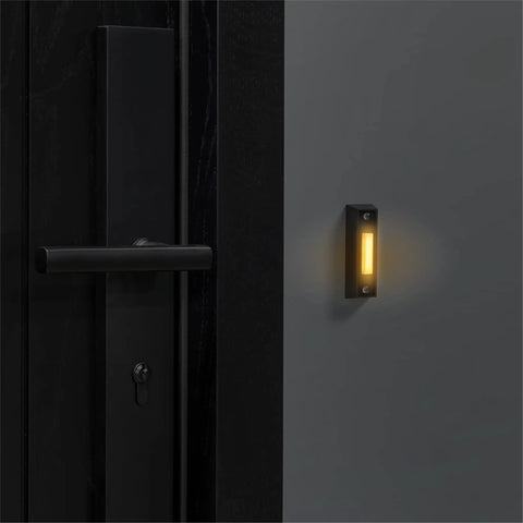 LED Lighted Doorbell Button In Black Plastic, No More Fumbling After Dark, Classic Rectangular Design near a door handle