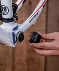 Using Eight Notch Cartridge Bottom Bracket Lockring Tool 44mm OD Pro Grade on bike frame, hand holding tool for Shimano SRAM ISIS drive.