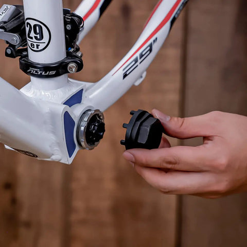 Using Eight Notch Cartridge Bottom Bracket Lockring Tool 44mm OD Pro Grade on bike frame, hand holding tool for Shimano SRAM ISIS drive.