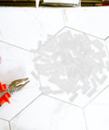 Double Headed Furniture Clips 100 Pack Adjustable Nut Design Nylon Connectors on a tiled surface with pliers.