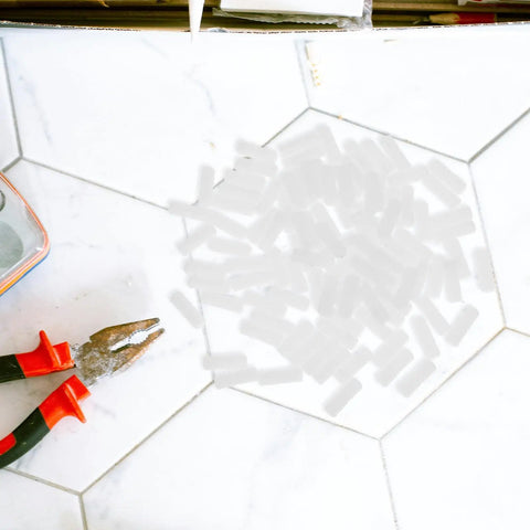 Rock Solid Hidden Fasteners For Furniture Assembly 100 Piece Nylon Cabinet Connectors with tools on white floor.