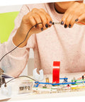ARTIBETTER 20pcs small electric motor clamp brackets; white clamps on a DIY electronics desk (front view).