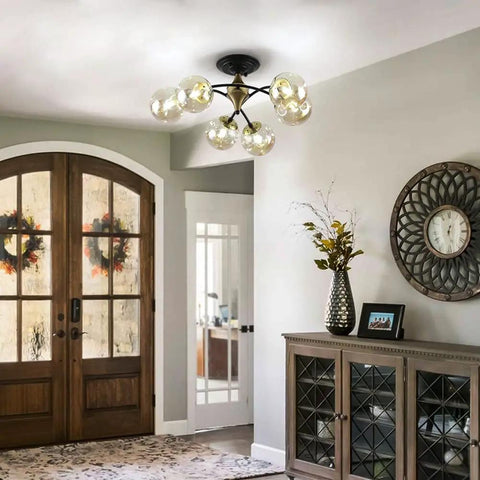 Modern entryway with Bold Black Chandelier Lighting With Glass Orbs illuminating, metal frame, complements decor