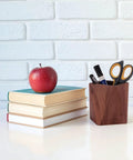 Black Walnut Wood Pen Holder For Desk on white surface with books and apple