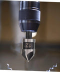 Close-up of a drill with a chamfer bit from the 5 Piece Countersink Drill Bit Set For Woodworking And Metal Fabrication With Pro Grade Precision Chamfering Tools Versatile Deburring Kit For Carpentry Projects And Metalworking Tasks.