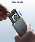 Hand holding open No Sweat 40Gbps M2 NVMe SSD Enclosure Rock Solid Aluminum Housing With Auto Thermostat Cooling Fan.