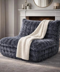 Dark grey faux fur memory foam bean bag chair with filler in front of a fireplace, cozy and soft for all rooms and daily lounging.