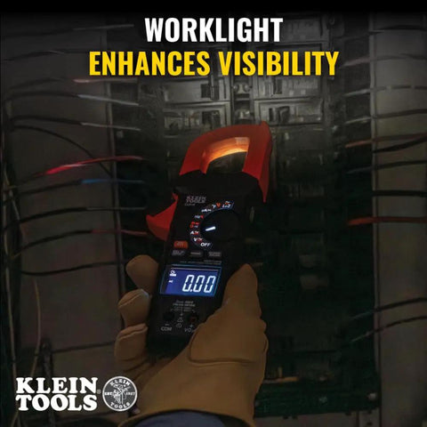 Electrician using Digital Clamp Meter With True RMS And LoZ Auto Ranging for AC DC voltage in dark panel box