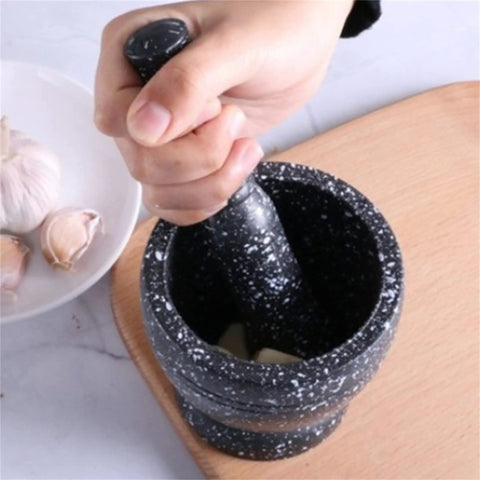 Hand using Heavy Duty Unpolished Granite Mortar And Pestle Set For Home Kitchen Grinds Guacamole Salsa Spices And Nuts Like A Pro