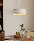 Modern Dome Yellow Travertine Pendant Light, spherical design in natural stone above a dining table setting.
