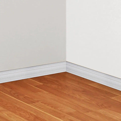 Peel And Stick 3D Crown Molding Foam Wall Border Self Adhesive Baseboard Trim White 2 Pack installed on white wall and wood floor corner