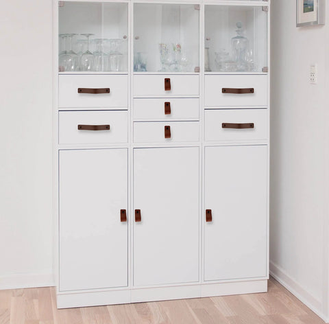 Leather Furniture Handles Set Two Pieces Cognac Leather Drawer Pulls on white cabinet in modern home