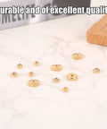 Brass Clock Hand Nut Kit With 12 Pieces In 5mm 6mm And 10mm OD Sizes Replacement Set displayed on a marble surface