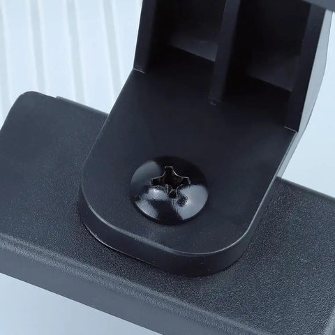 Close-up of Tough As Nails Heavy Duty 3/8-16 X 1-1/2 Phillips Truss Head Machine Screw installed on a black surface.