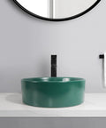 Bathroom Sink Bathroom Round Non-Porous Ceramic Wash Basin Dark Green Wash Basin on a countertop with black faucet.