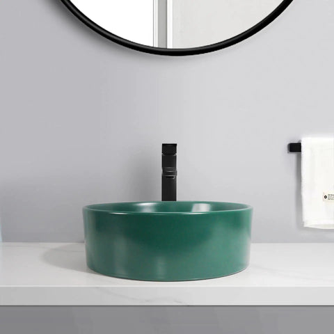Bathroom Sink Bathroom Round Non-Porous Ceramic Wash Basin Dark Green Wash Basin on a countertop with black faucet.