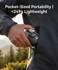 Person placing foldable 4K GPS Drone With 4.5 Inch HD Controller Screen into jacket pocket outdoors, highlighting portability.