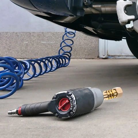 Air impact wrench on concrete next to car, blue hose for use with All in One Copper Washers Kit for Auto Body Dent Repair Grab and Go 200 Pcs.