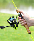 Person holding a lightweight spinning reel with ultra smooth action for saltwater and freshwater, 20 lb drag, 5.2:1 gear ratio.