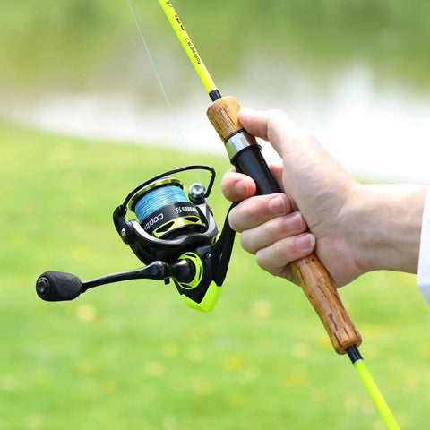 Person holding a lightweight spinning reel with ultra smooth action for saltwater and freshwater, 20 lb drag, 5.2:1 gear ratio.