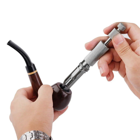 Adjustable Stainless Steel Tobacco Pipe Reamer Tool With 3 Level Handle in use, cleaning a wooden pipe bowl.