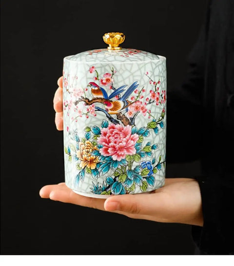 Premium Vintage Enamel Ceramic Tea Storage Jar Airtight Large Capacity Dry Food Canister For Coffee Beans Spices Nuts And Loose Leaf Tea in hand, decorated with flowers and birds.