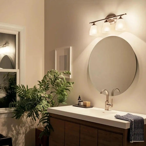 Bathroom with Ansonia 23-Inch Three Light Vanity Fixture with Satin Etched Glass and Brushed Nickel Finish, modern style.