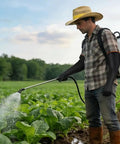 Man using Tough As Nails 22 Inch Heavy Duty Rubber Gloves For Household Chores And Professional Cleaning Reusable Chemical Resistant Safety Gear With Ergonomic Comfort Fit while spraying crops.