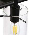Close-up of black metal fixture with clear glass shade, showing bulb and details for 3-Light Gold Vanity Light With Seeded Glass Shades For Bathroom Over Mirror, Sleek Fixture With Cozy Glow And Luxe Seeded Glass Finish, 24.5 Inch Long Bath Vanity Lighting.