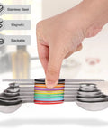 Hand holding Magnetic Dual Sided Stainless Steel Measuring Spoons Set 7 Piece With Leveler for compact nesting and rustproof design.