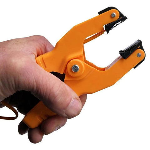 Close-up of a hand holding a clamp included with the Type K Dual Channel Digital Thermometer For Pipe Temperature