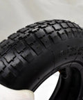 Close-up of a Beefy 8 Inch Wheelbarrow Tire With Inner Tube 3.25 3.00-8 4PR 25 PSI Max showing tread pattern and valve.