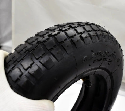 Close-up of a Beefy 8 Inch Wheelbarrow Tire With Inner Tube 3.25 3.00-8 4PR 25 PSI Max showing tread pattern and valve.