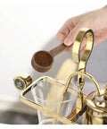 Top Shelf Siphon Coffee Maker Syphon Glass Brewer 4 Cup with hand holding wooden scoop of coffee grounds.
