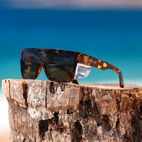 ANSI Z87+ Safety Sunglasses Packing Polarized Lenses To Vaporize Glare For Work, Surf, And PPE Missions on a wooden surface.