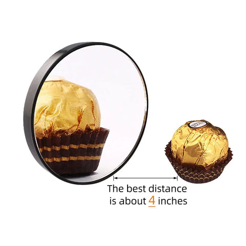 10X Magnifying Makeup Mirror With Stainless Steel Tweezers Portable Round Mirror reflecting a chocolate, showing magnification at 4 inches