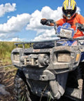 ATV equipped with PE3500 3500 Lb ATV Winch With 50 Ft Synthetic Rope Waterproof 2.4 HP Permanent Magnet Motor in muddy terrain