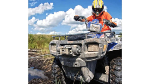 ATV equipped with PE3500 3500 Lb ATV Winch With 50 Ft Synthetic Rope Waterproof 2.4 HP Permanent Magnet Motor in muddy terrain