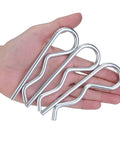 Hand holding 4-Piece Set Of Rock-Solid M6 X 120 White Zinc Plated Cotter Pins And R-Clips, spring retaining hair pins